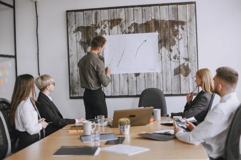 Group of business professionals discussing strategies with growth chart in conference room. — Access a Wide Variety of Strain