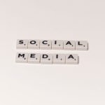 Scrabble tiles spelling 'social media' on a white background, representing digital communication concepts. — Boost Your Agenc