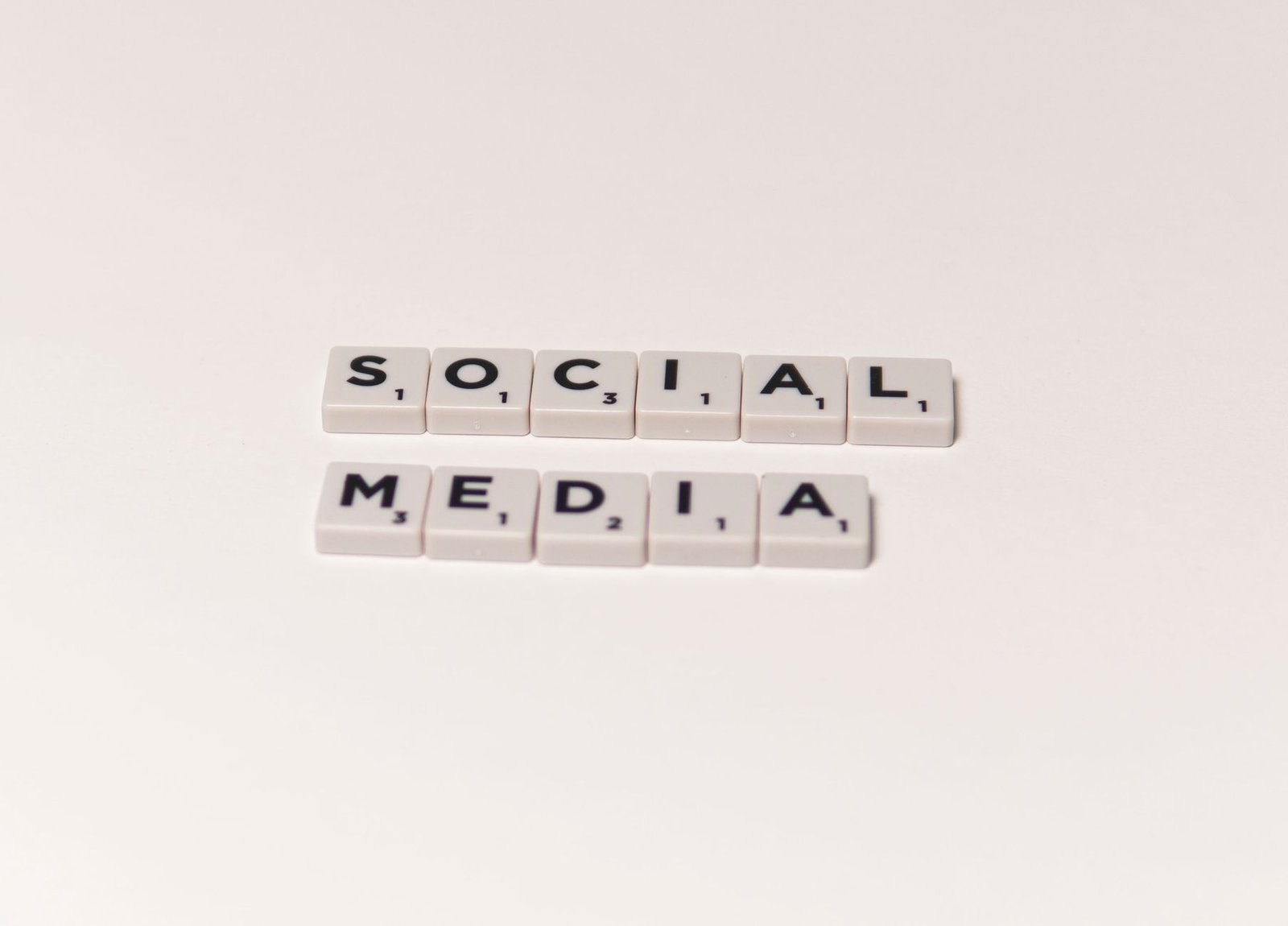 Scrabble tiles spelling 'social media' on a white background, representing digital communication concepts. — Boost Your Agenc