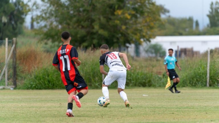 Two young soccer players competing during a match outdoors on a grassy field. — Enjoy Free NFL Streaming Options