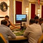 A group of adults playing at a casino table in Goa, India, captured indoors with festive decor. — Find Trusted Platforms with