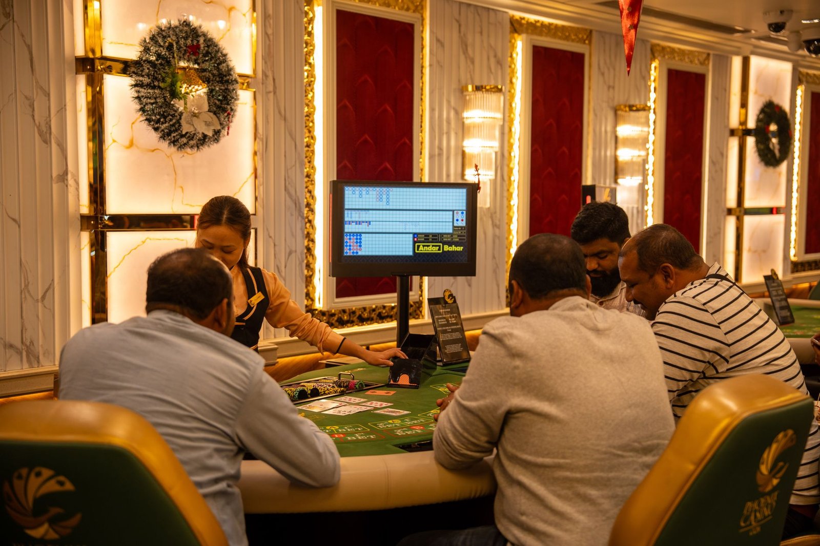 A group of adults playing at a casino table in Goa, India, captured indoors with festive decor. — Find Trusted Platforms with