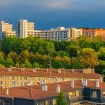 A scenic urban landscape featuring modern buildings and lush greenery at sunset. — Gain Clarity on Tenant Obligations with an