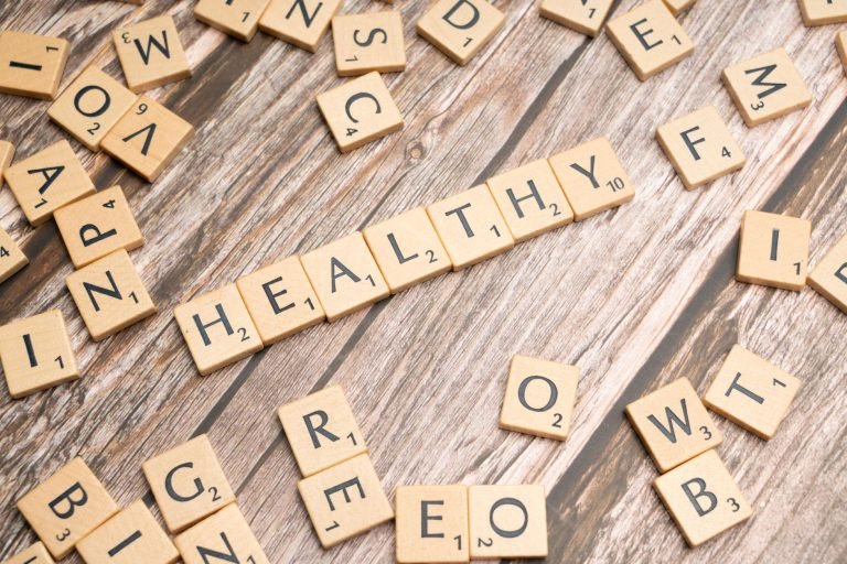 Wooden letter tiles arranged on a wooden surface spelling out 'healthy', symbolizing wellness. — How a Master of Physician As