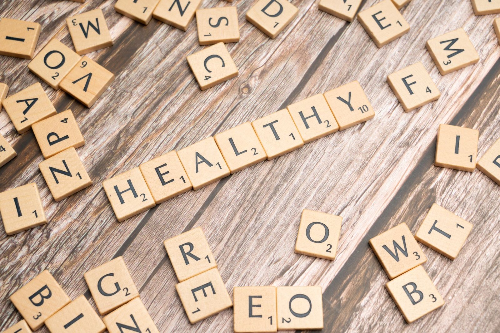 Wooden letter tiles arranged on a wooden surface spelling out 'healthy', symbolizing wellness. — How a Master of Physician As