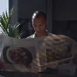 Businessman focused on reading newspaper in a sunny indoor office setting. — Risk Management Mastery: Safeguarding Your Inves