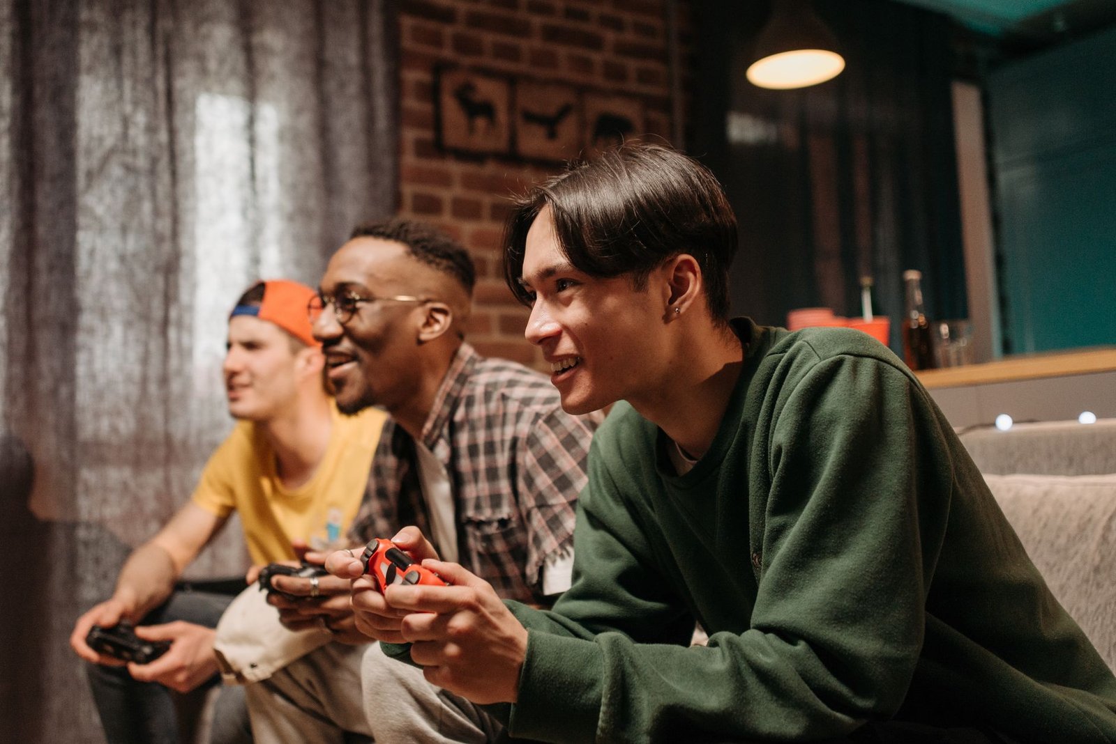 Diverse group of young adults enjoying video games together indoors, creating a fun and social atmosphere. — Safe Toto Platfo