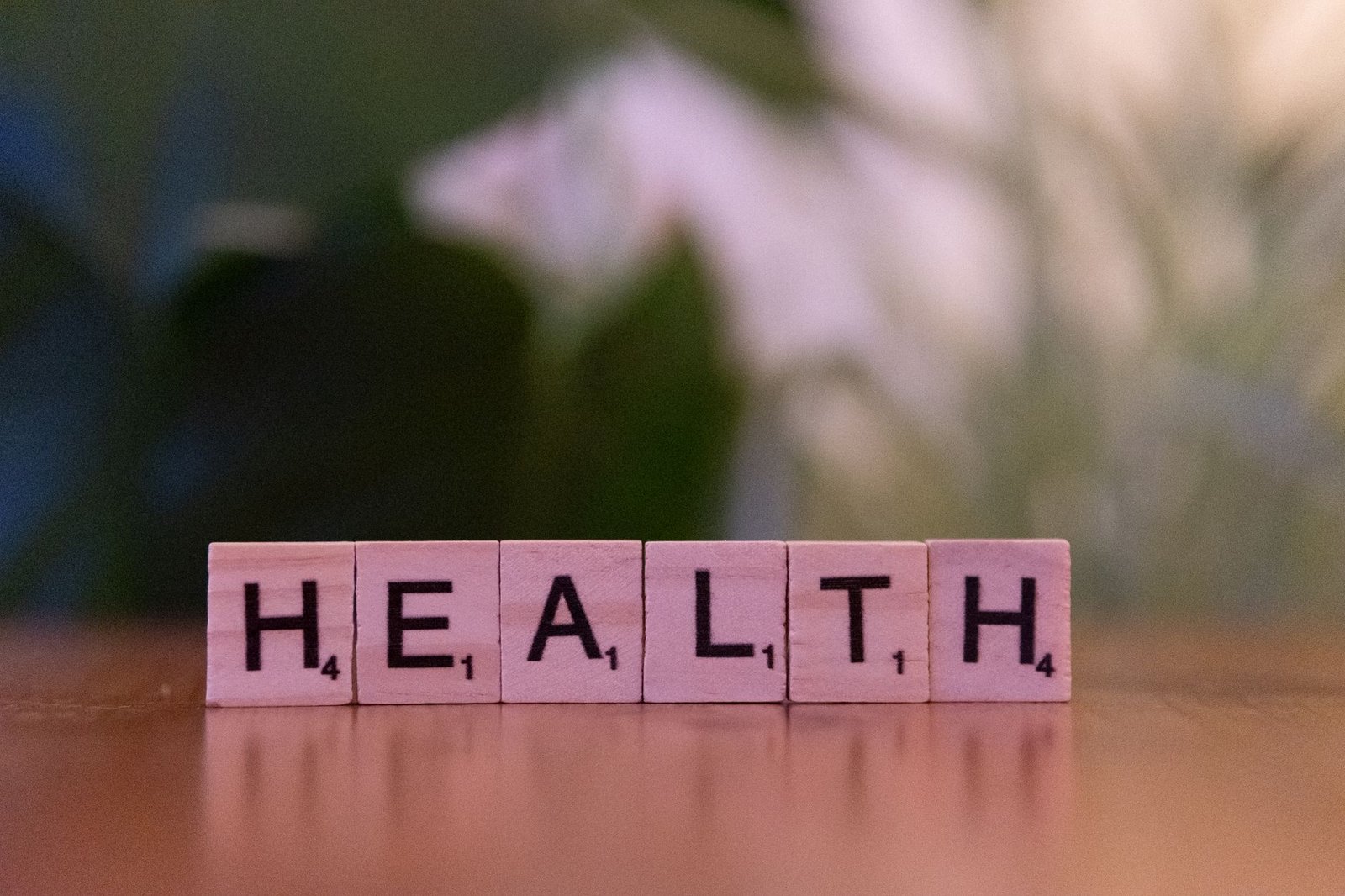 Close-up of Scrabble tiles spelling 'Health' on a wooden table with a blurred background. — Safe Ways to Order Testosterone O