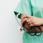 Close-up of a healthcare worker holding a stethoscope, showcasing medical professionalism. — Your Guide to Tantric Massage Ou